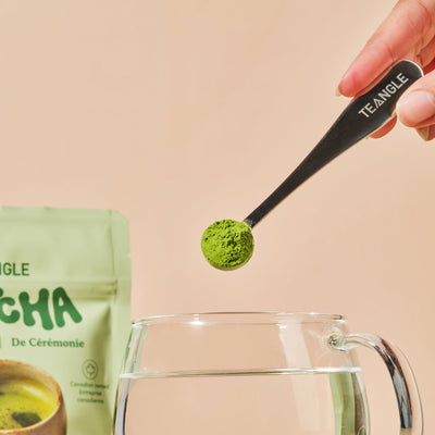 Matcha powder being added to water with spoon